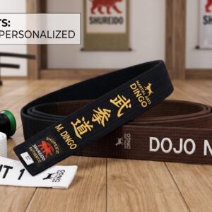 A curated flat lay of a Shureido heavy-weight gi, custom-embroidered black belt, and instructor patches from Martial Arts Dingo, representing the Premium Instructor Set.