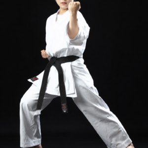 Female black belt martial artist striking a deep front stance, wearing a white Shureido Medium Weight All-Purpose GI