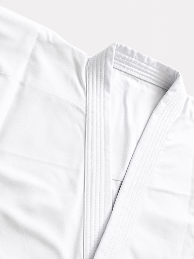 Close-up detail of the reinforced collar stitching and lightweight fabric texture on the Shureido New Wave NW-1 Kumite jacket