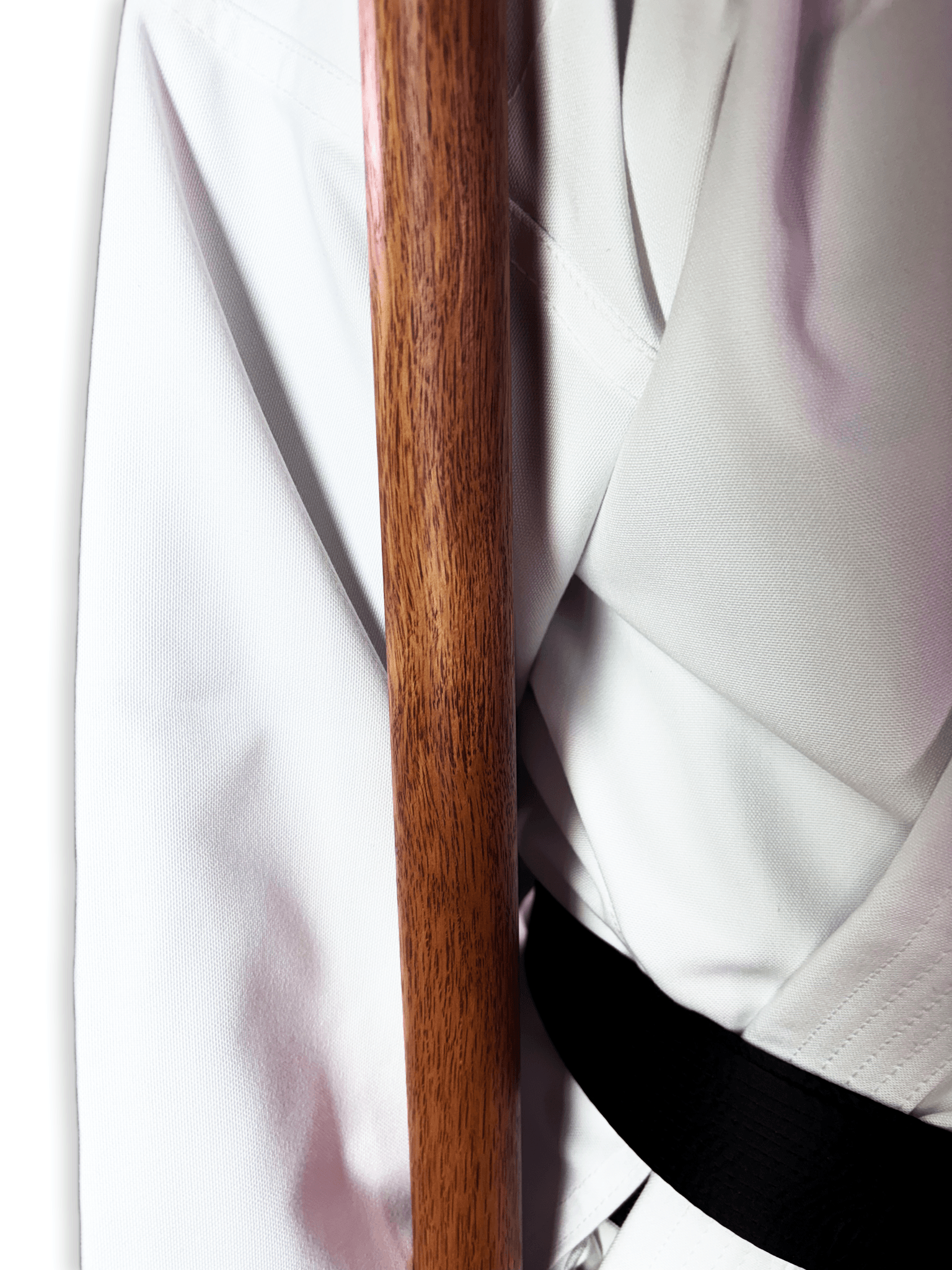 Close-up view of the engraved Shureido Okinawa brand logo and text on the ends of traditional wooden bo staffs.