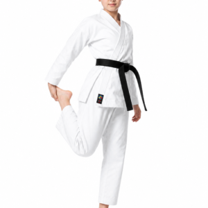 Young female black belt performing a standing quad stretch, showcasing the mobility of the white Shureido TKB-10 Professional Gi.