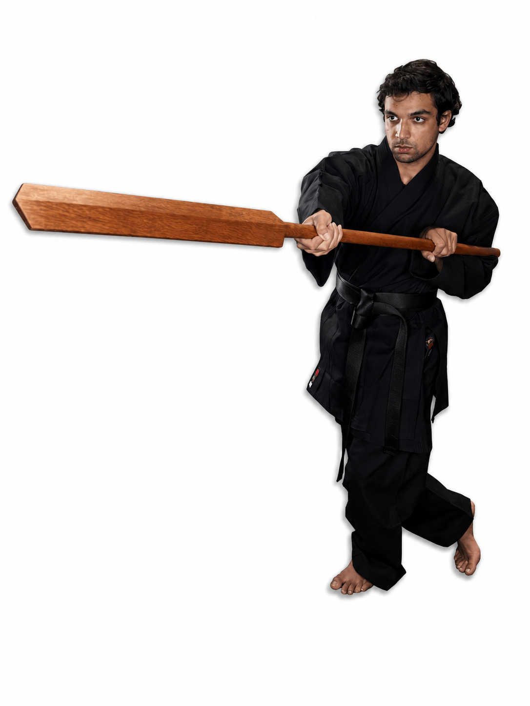 Karate practitioner in a black gi executing a striking or thrusting posture with a traditional wooden Shureido Okinawan eku oar.