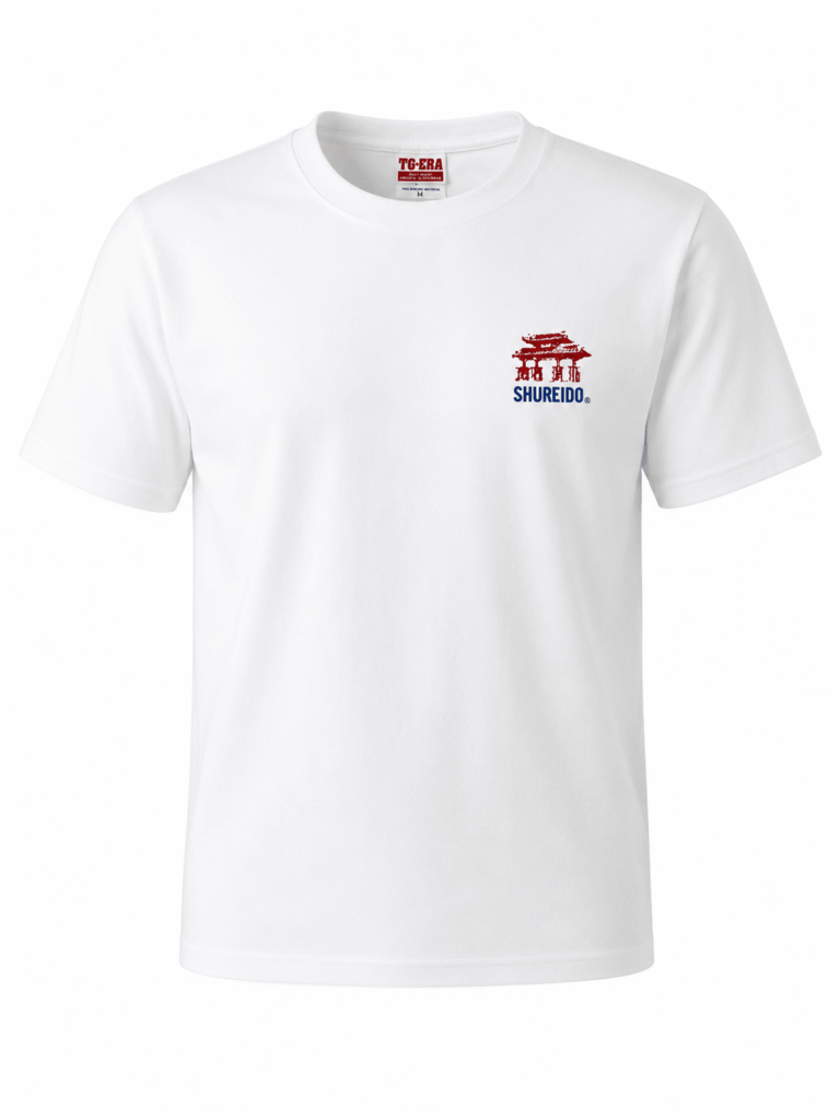 White Shureido karate t-shirt featuring a blue Japanese kanji graphic on the front left chest against a plain background.